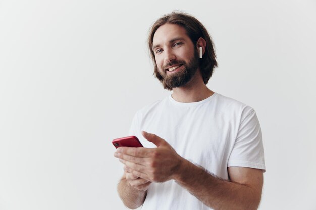 Portrait of young man using mobile phone against white background