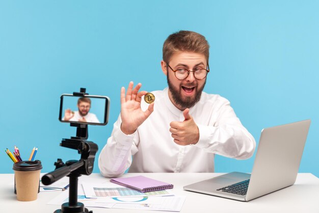 Portrait of young man using smart phone on table