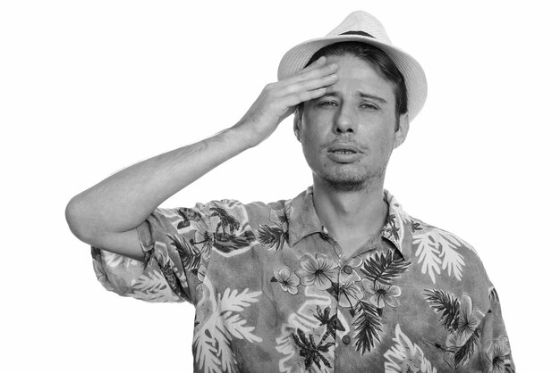 Portrait of young man wearing hat against white background