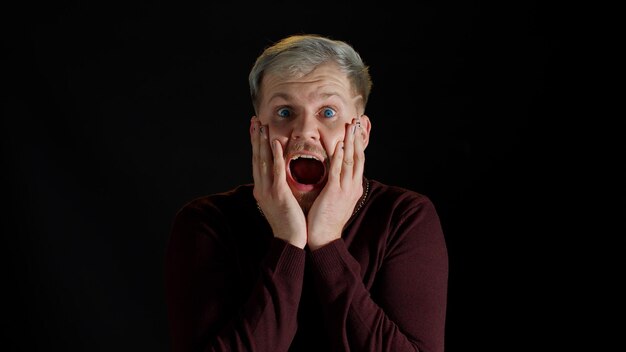 Photo portrait of young man wearing mask against black background