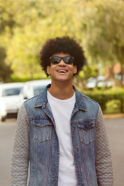 Portrait of young man wearing sunglasses standing outdoors