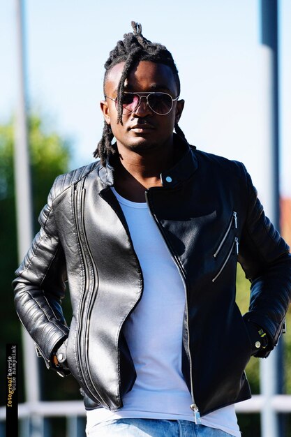 portrait of young man wearing sunglasses standing outdoors