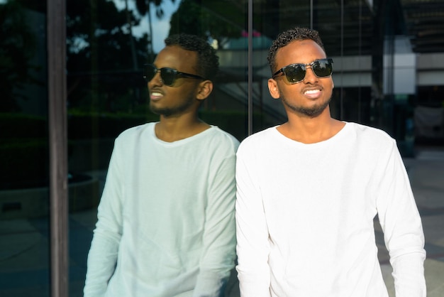 portrait of young man wearing sunglasses standing outdoors
