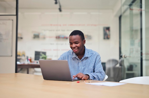 portrait of young man while working with a computer in the office