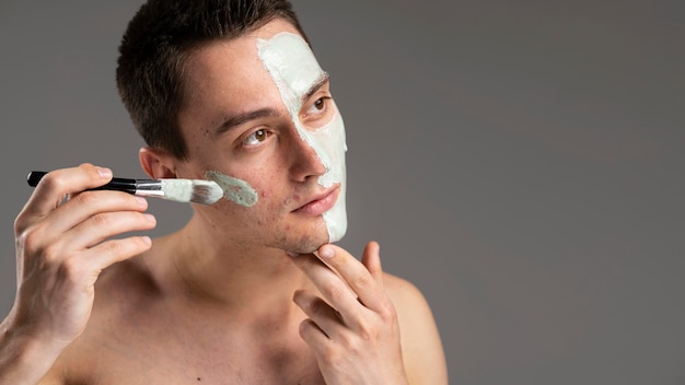 Portrait of young man with acne and copy space