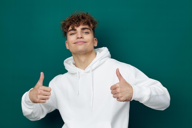 Portrait of young man with arms crossed against blue background