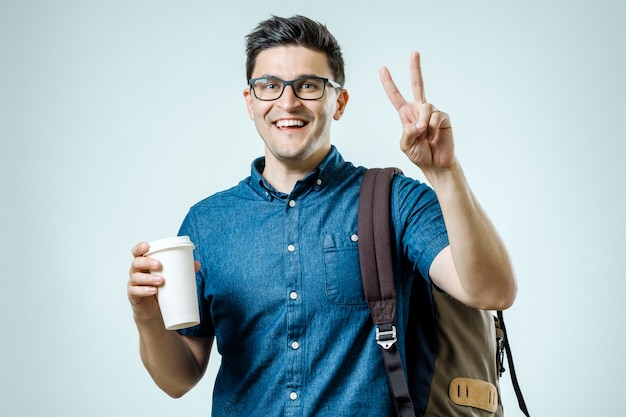 Portrait of young man with backpack isolated