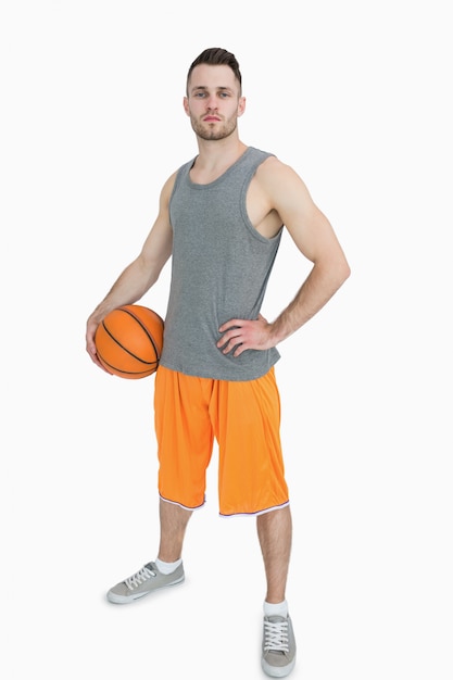 Portrait of young man with basketball