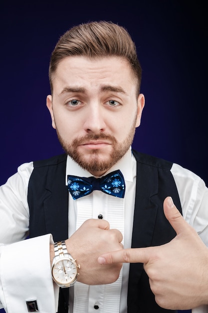 Portrait of young man with beard shows to watch