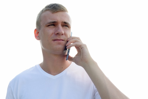 Portrait of young man with blond hair against view of the clear sky outdoors