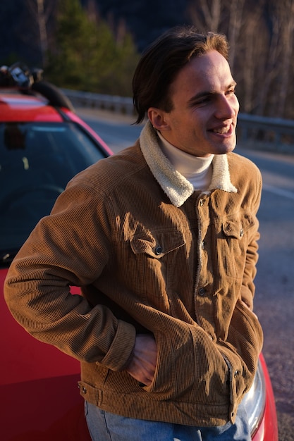 Portrait of a young man with a car