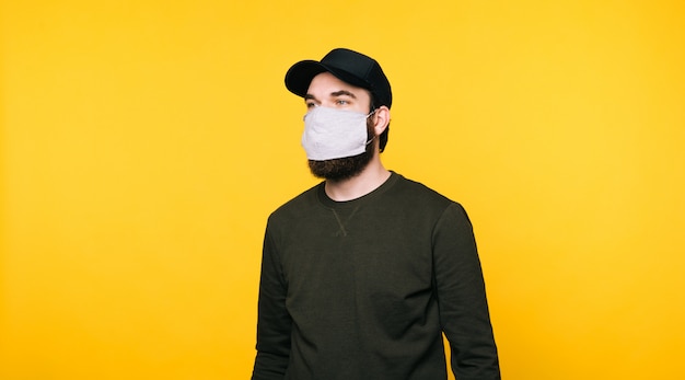 Portrait of young man with facial mask looking away