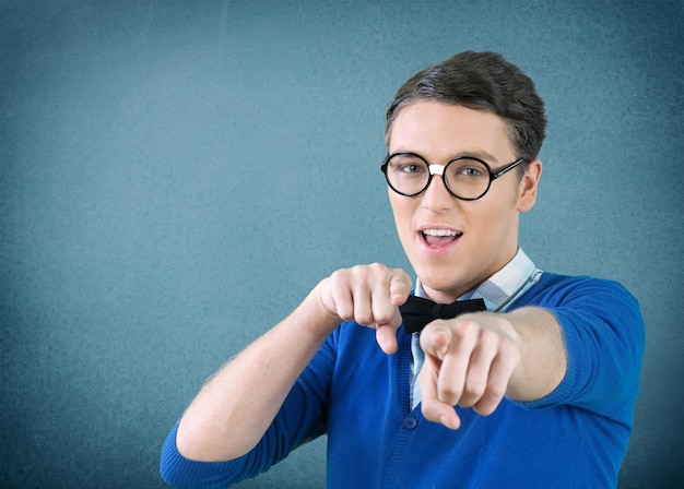 Portrait of young man with glasses showing at camera