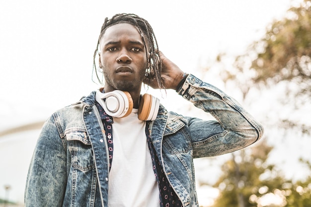 Photo portrait of young man with headphones standing in city