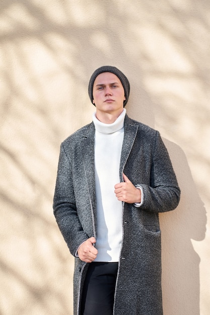 portrait young man with jacket and cap outdoor