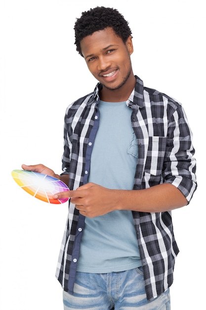 Photo portrait of a young man with paint samples