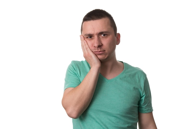 Portrait Of Young Man With Sensitive Tooth Ache Crown Problem  Suffering From Pain Touching Outside Mouth With Hand Isolated On White Background