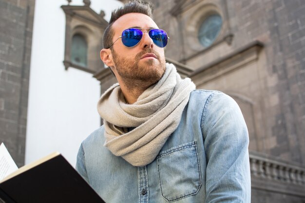 Portrait young man with sunglasses in the street