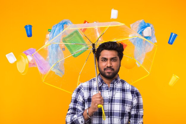 Portrait of young man with umbrella