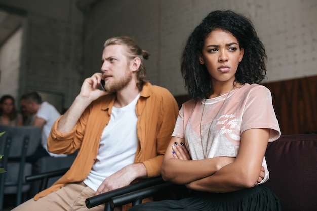 Portrait of young man and woman sitting at cafe