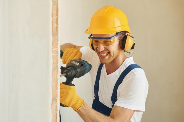 Portrait of young man working in uniform at construction at daytime