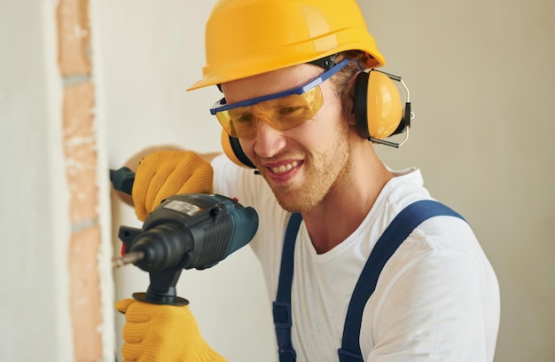 Portrait of young man working in uniform at construction at daytime