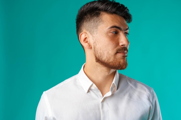 Portrait of a young mixed race businessman against blue background