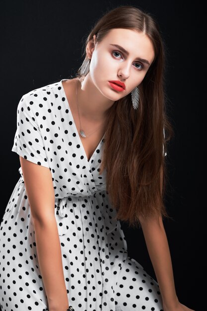 Portrait of a young model in studio against black.