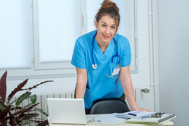 Portrait of young nurse in blue uniform