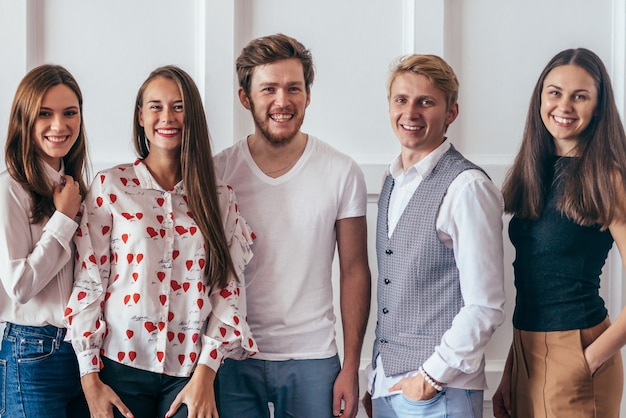 Portrait of young people standing together and smiling.