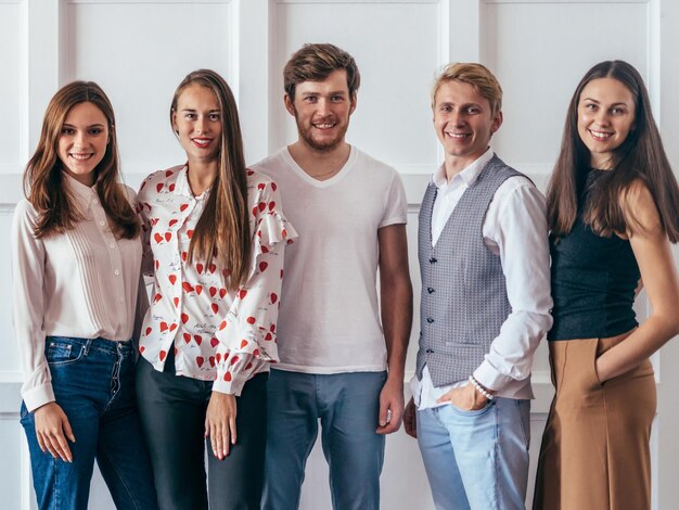 Portrait of young people standing together and smiling