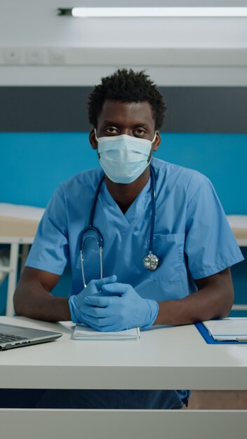 Portrait of young person working as nurse in cabinet