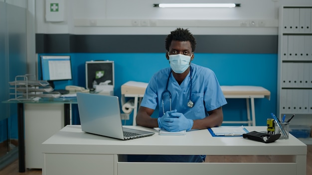 Portrait of young person working as nurse in cabinet