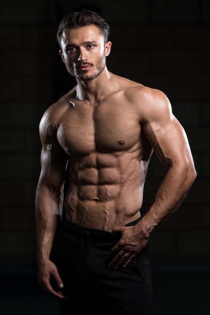 Portrait Of A Young Physically Fit Man Showing His Well Trained Body  Muscular Athletic Bodybuilder Fitness Model Posing After Exercises