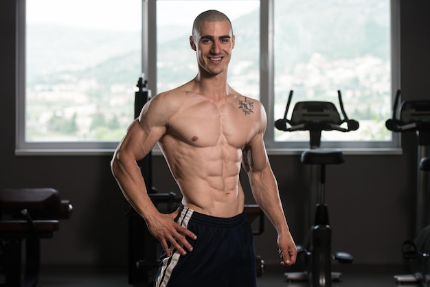 Portrait Of A Young Physically Fit Man Showing His Well Trained Body Muscular Athletic Bodybuilder Fitness Model Posing After Exercises