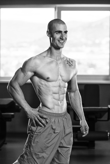 Portrait Of A Young Physically Fit Man Showing His Well Trained Body Muscular Athletic Bodybuilder Fitness Model Posing After Exercises