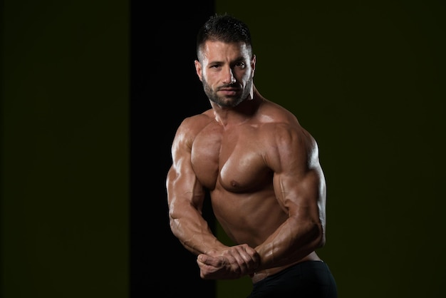 Portrait Of A Young Physically Fit Man Showing His Well Trained Body  Muscular Athletic Bodybuilder Fitness Model Posing After Exercises