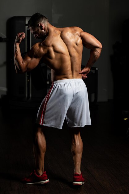 Portrait Of A Young Physically Fit Man Showing His Well Trained Body  Muscular Athletic Bodybuilder Fitness Model Posing After Exercises