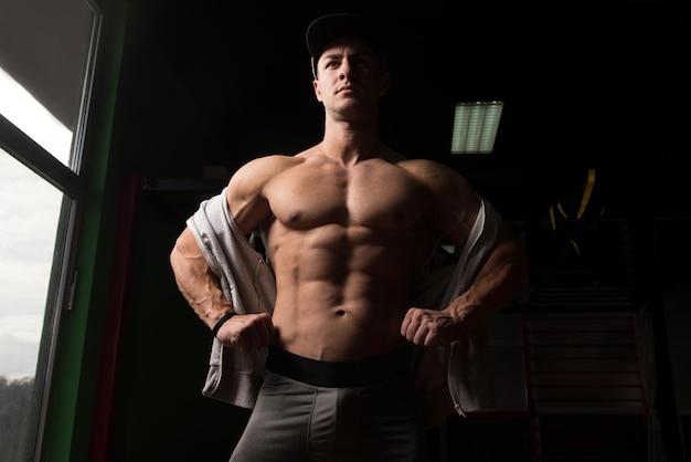 Portrait Of A Young Physically Fit Man Showing His Well Trained Body  Muscular Athletic Bodybuilder Fitness Model Posing After Exercises