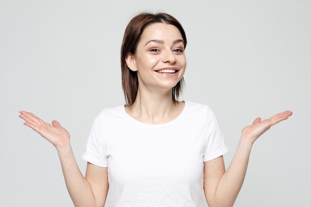 Portrait of young positive female with cheerful expression