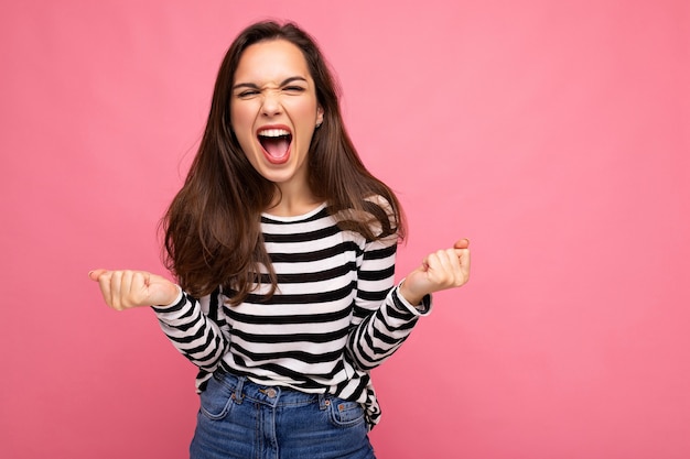 Portrait of young positive happy beautiful brunette woman with sincere emotions wearing casual