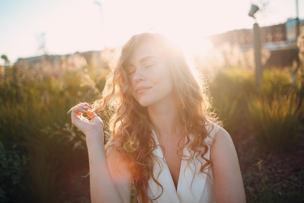 Portrait of young positive woman with curly hair