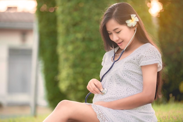 Portrait of young pregnant woman at the parkThailand people