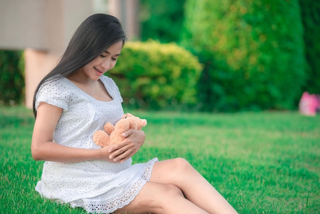 Portrait of young pregnant woman at the parkThailand people