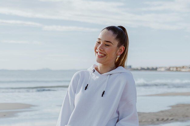 Portrait of a young pretty girl against the background of the sea