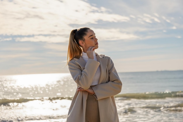 Portrait of a young pretty girl on the background of the sea