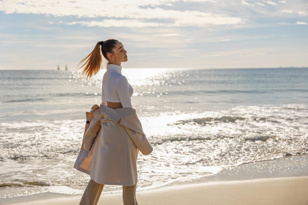 Portrait of a young pretty girl on the background of the sea