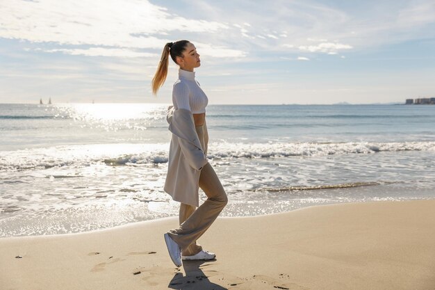 Portrait of a young pretty girl on the background of the sea