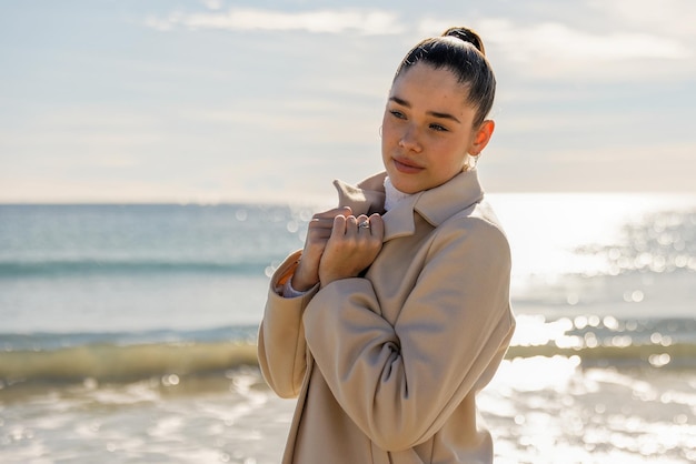 Portrait of a young pretty girl on the background of the sea