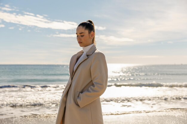 Portrait of a young pretty girl on the background of the sea